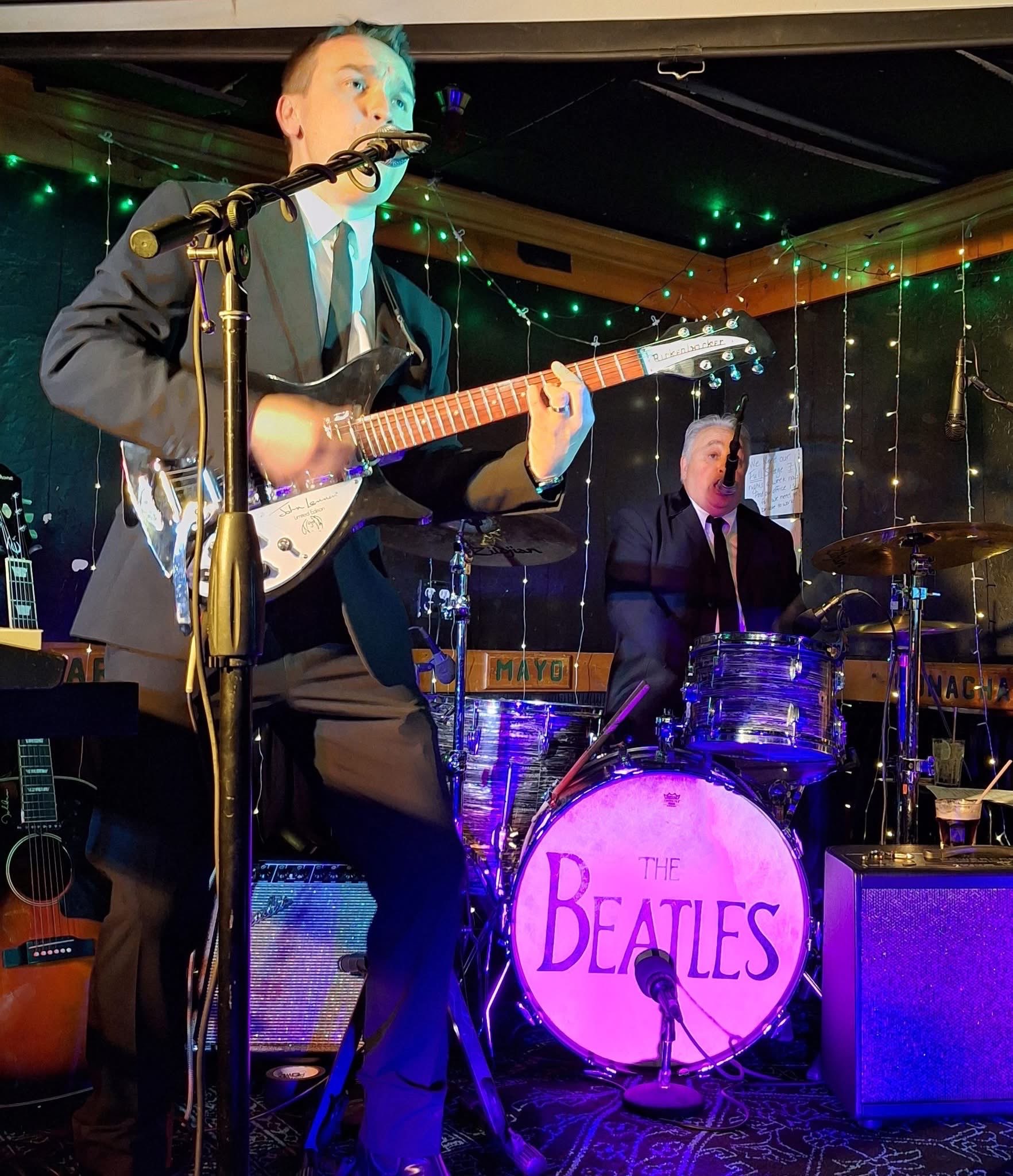 Boots & Suits bassist singing with a violin bass